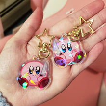Load image into Gallery viewer, Kirb Sitting With Knife - Double Sided 1.5&quot; Holographic Charm
